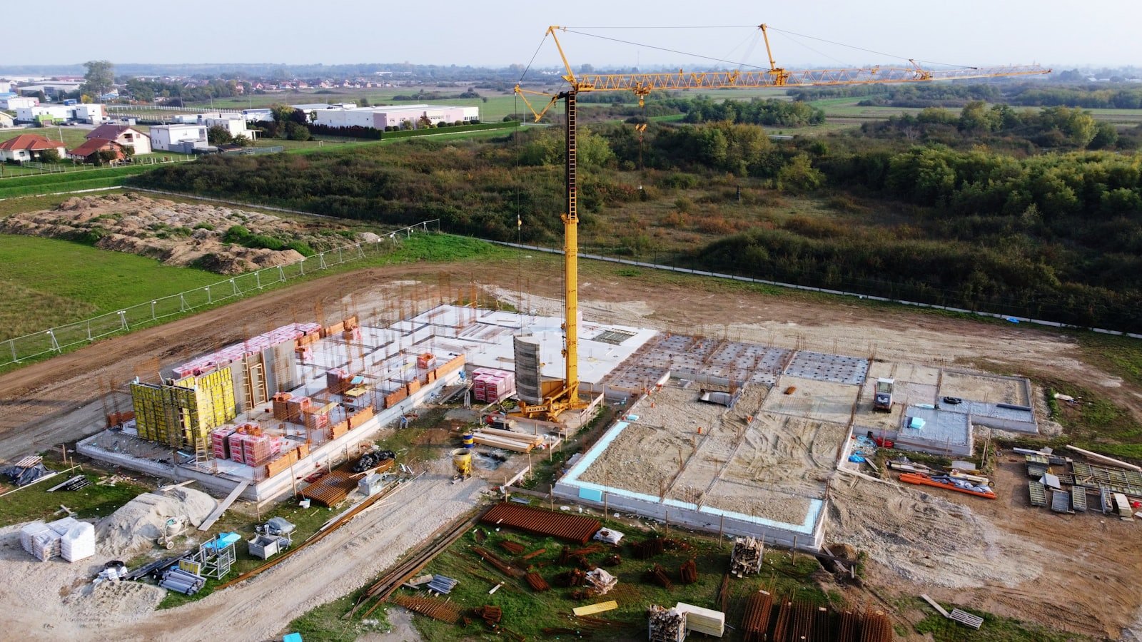 Aerial view of an active construction site with a tower crane