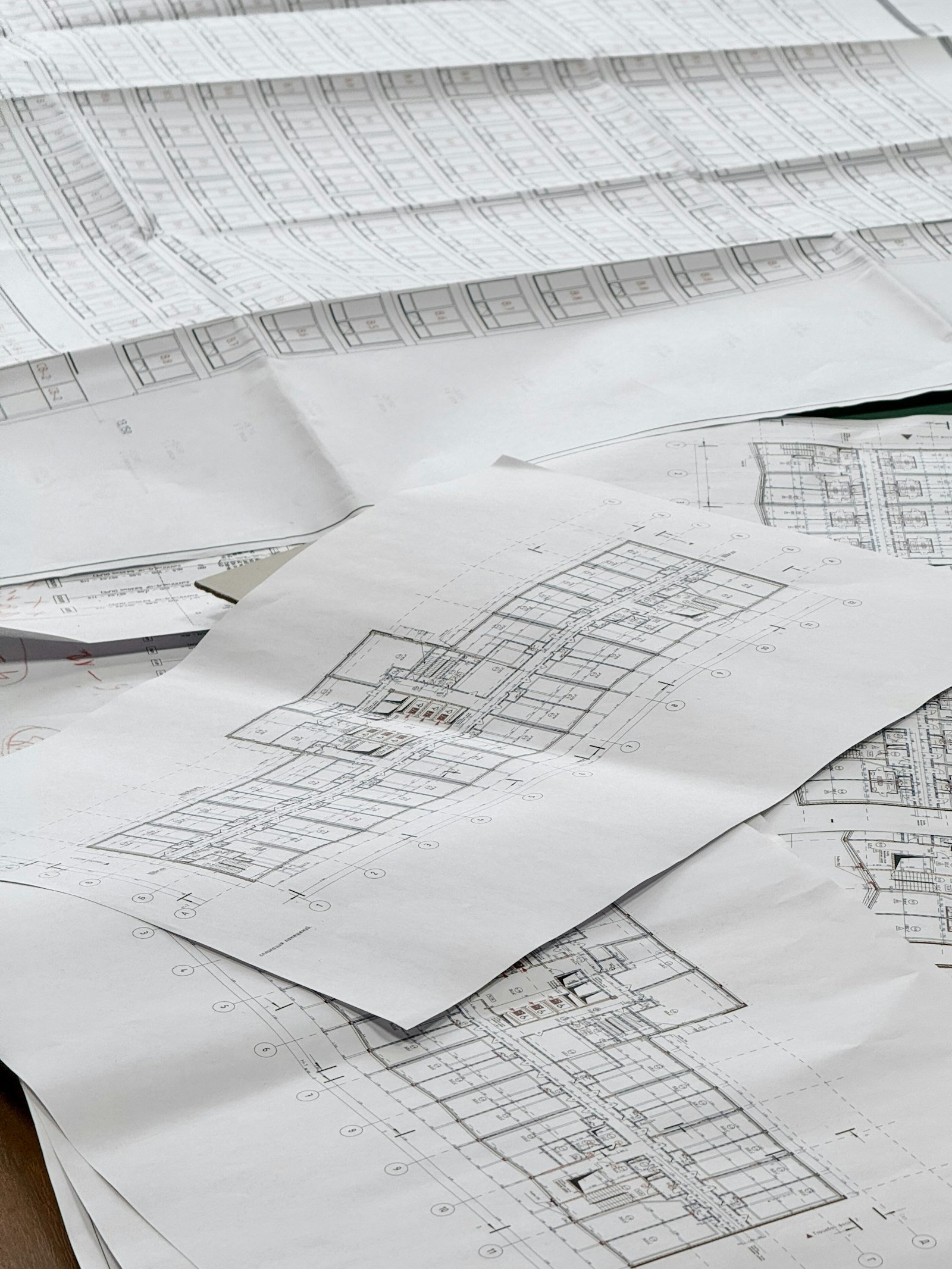 Architectural drawings spread across a work surface